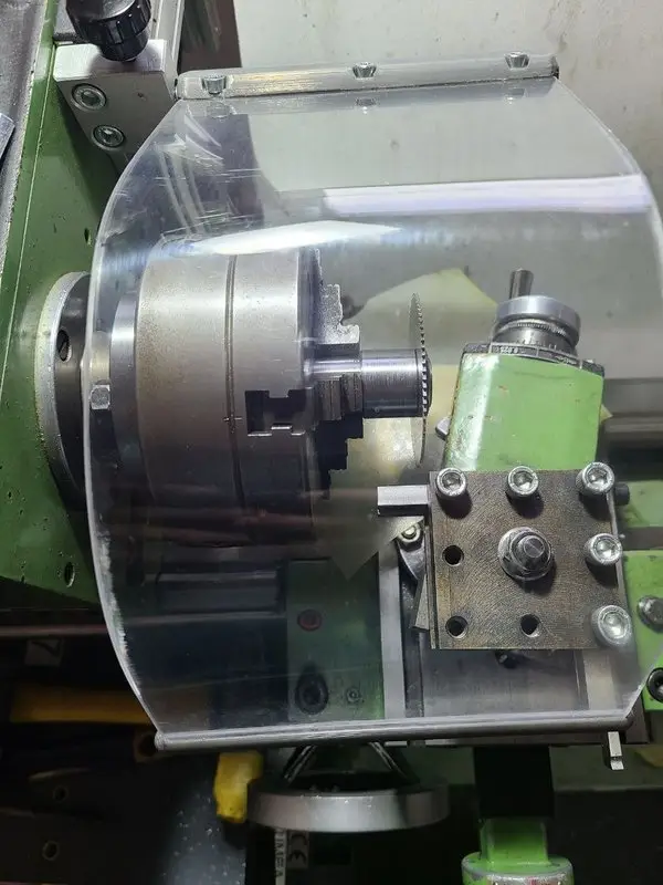 Homemade slitting-saw holder cutting a C45 profiled blank to length