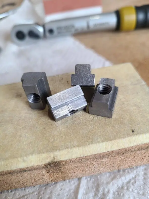 T-nut with a slightly off-center M6 threaded hole beside the successful parts